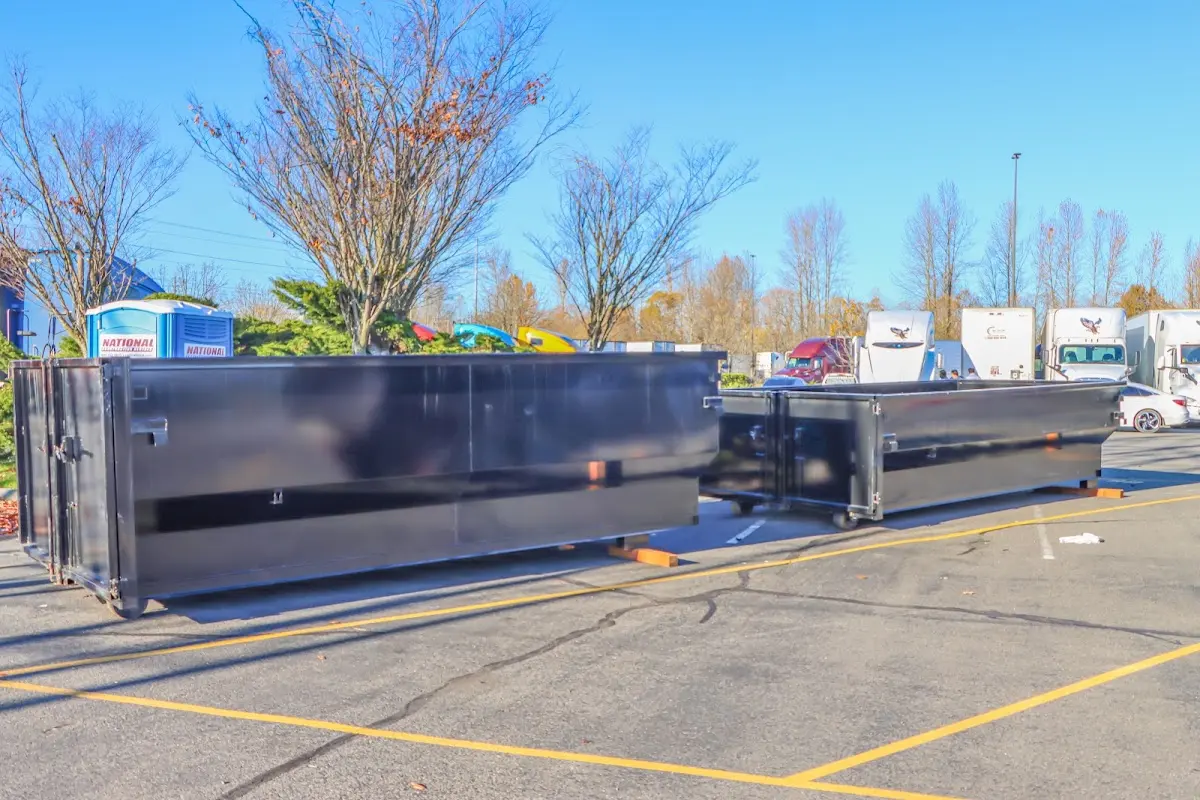 Professional dumpster rental service with roll-off container on residential driveway in Winnemucca